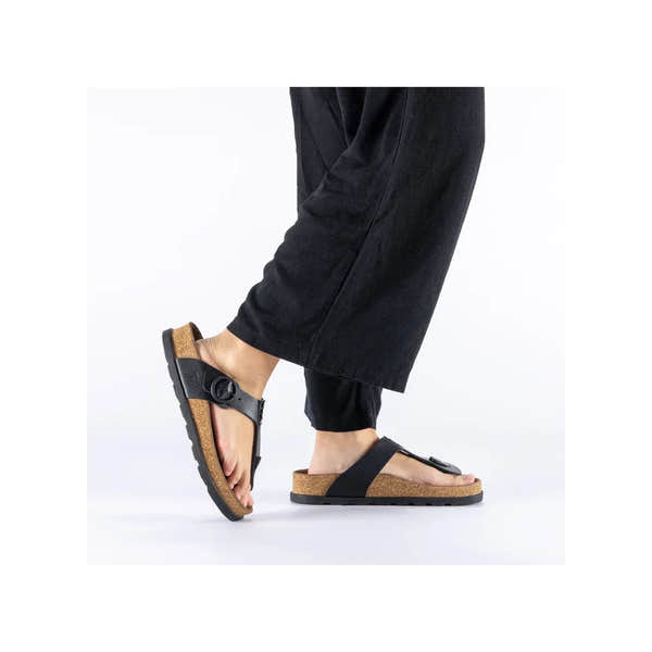 Rieker V3150-00 women's black leather buckle mule sandals with cork footbed and adjustable strap.