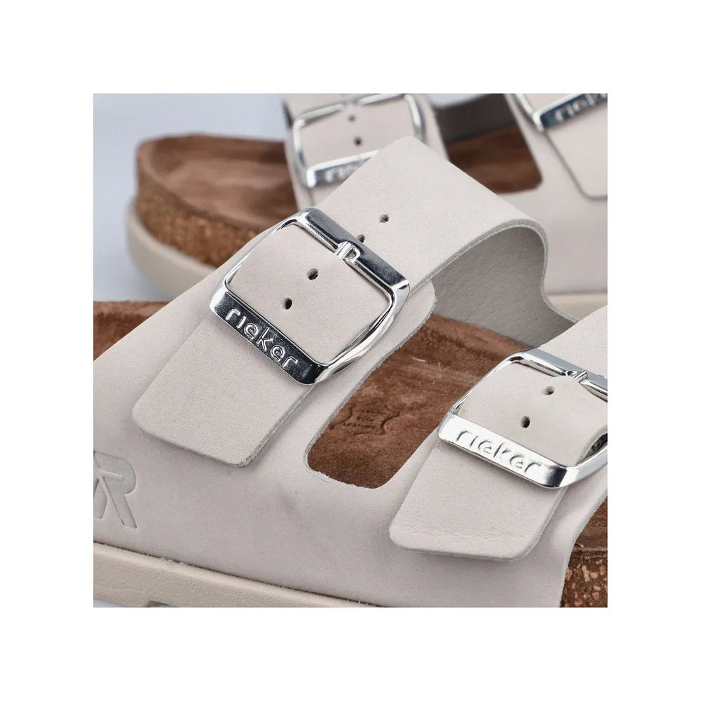 Rieker V3190-40 women's off-white leather buckle mule sandals with silver buckles and cork footbed.