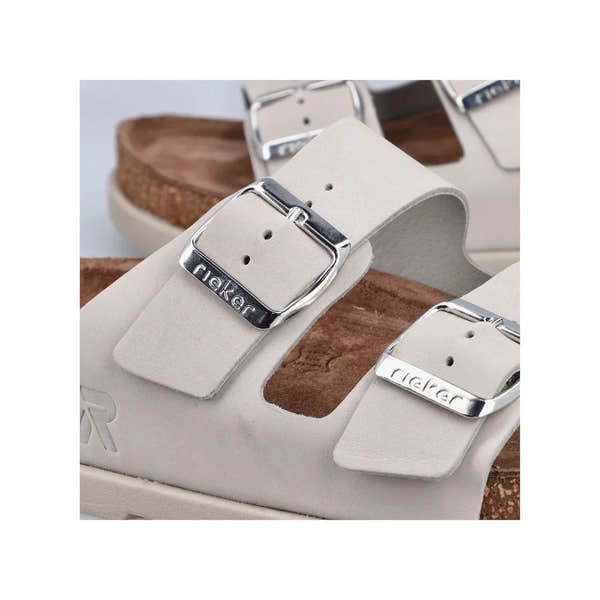 Rieker V3190-40 women's off-white leather buckle mule sandals with silver buckles and cork footbed.