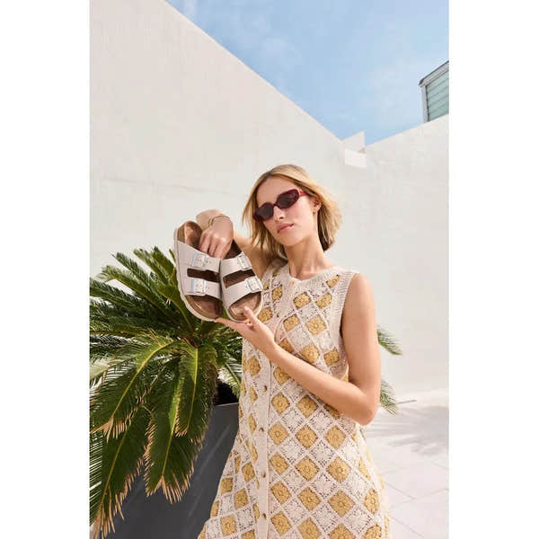 Rieker V3190-40 women's off-white leather buckle mules with open toe and stylish design.