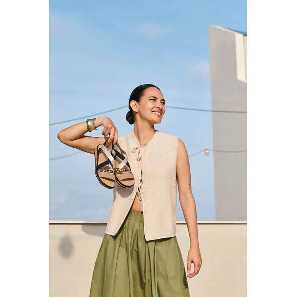 Rieker V3663-92 ladies multi-touch fastening sandals held by smiling woman outdoors with blue sky background.