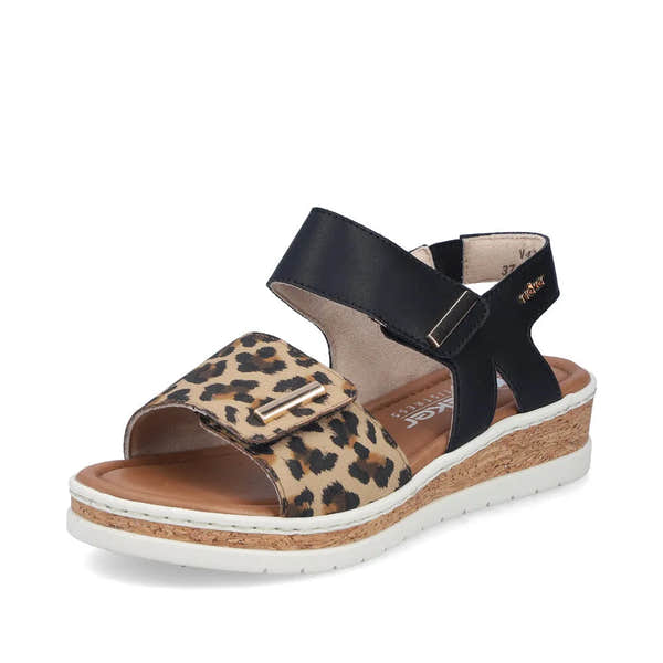 Rieker V4181-00 women's wide fit touch fastening sandals with leopard print strap, black ankle strap, cork wedge sole, and white rubber outsole.
