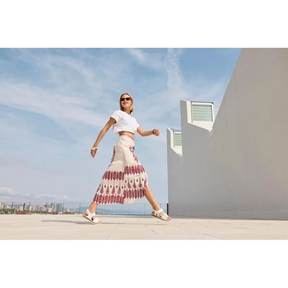 Rieker V4181-80 ladies wide white touch fastening sandals worn by a woman outdoors on a rooftop.
