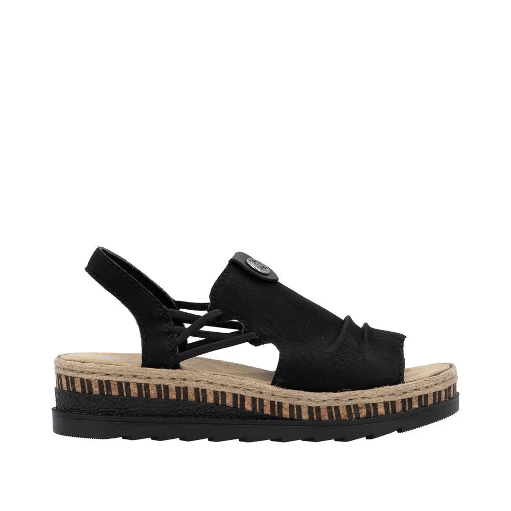 Black slip-on sandals with elastic straps, textured fabric upper, beige insole, and a layered black and striped platform sole.