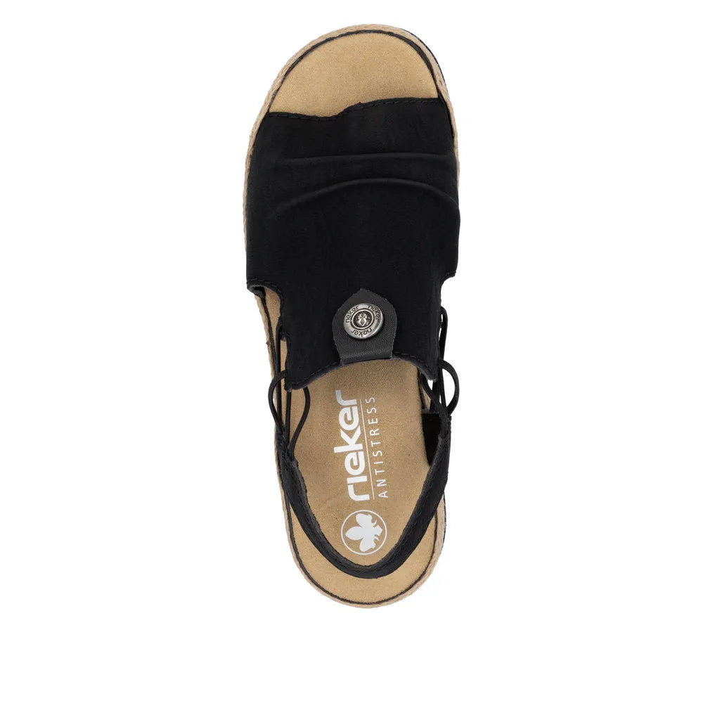 Black slip-on sandal with a cushioned beige insole and black adjustable laces, featuring a round metal logo detail.