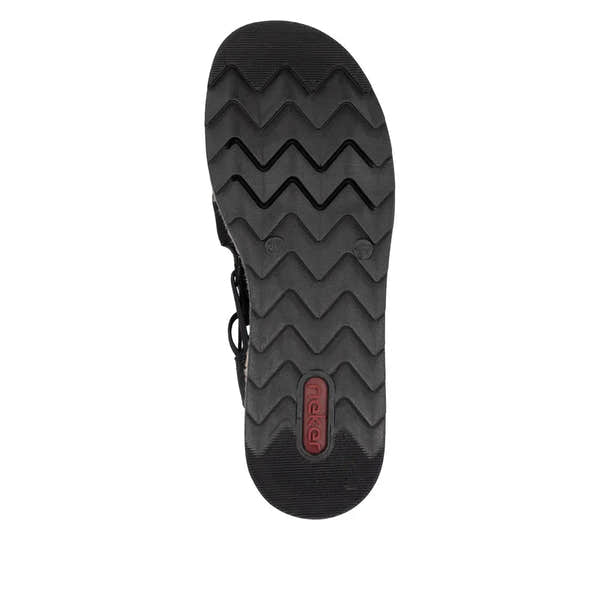 Black slip-on sandals with textured straps and a chunky rubber sole featuring zigzag tread pattern.