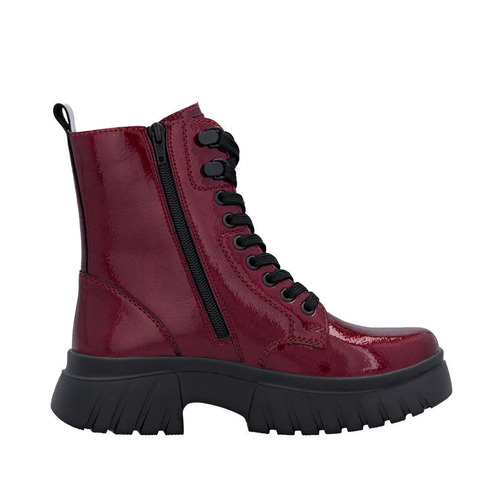 Rieker W1870-35 women's red patent leather ankle boots with zipper and lace-up front, chunky black sole, and pull tab.