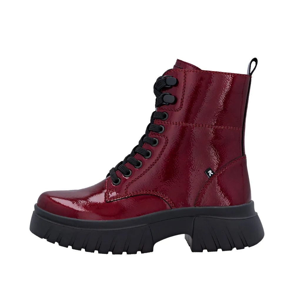 Rieker W1870-35 women's red patent leather ankle boots with lace-up design, zipper, and chunky sole.