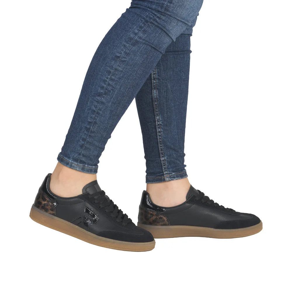 Rieker W2200-03 women's black leather lace-up trainers with leopard print accents and tan sole.