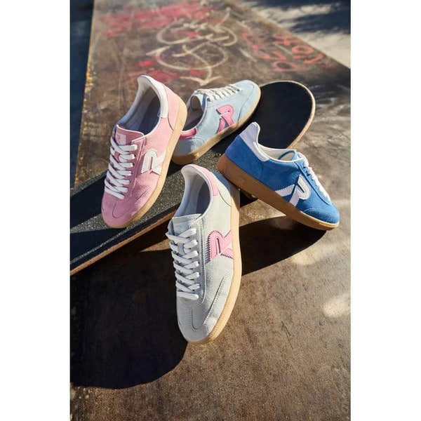 Light blue and pink suede lace-up trainers with white and pink accents, rubber soles, and a sporty style.