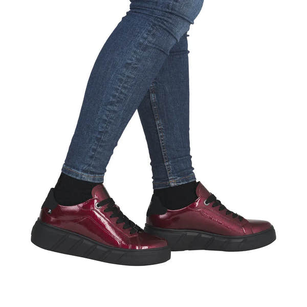 Rieker W2601-35 women's red patent leather lace-up trainers with chunky black soles, stylish casual footwear.