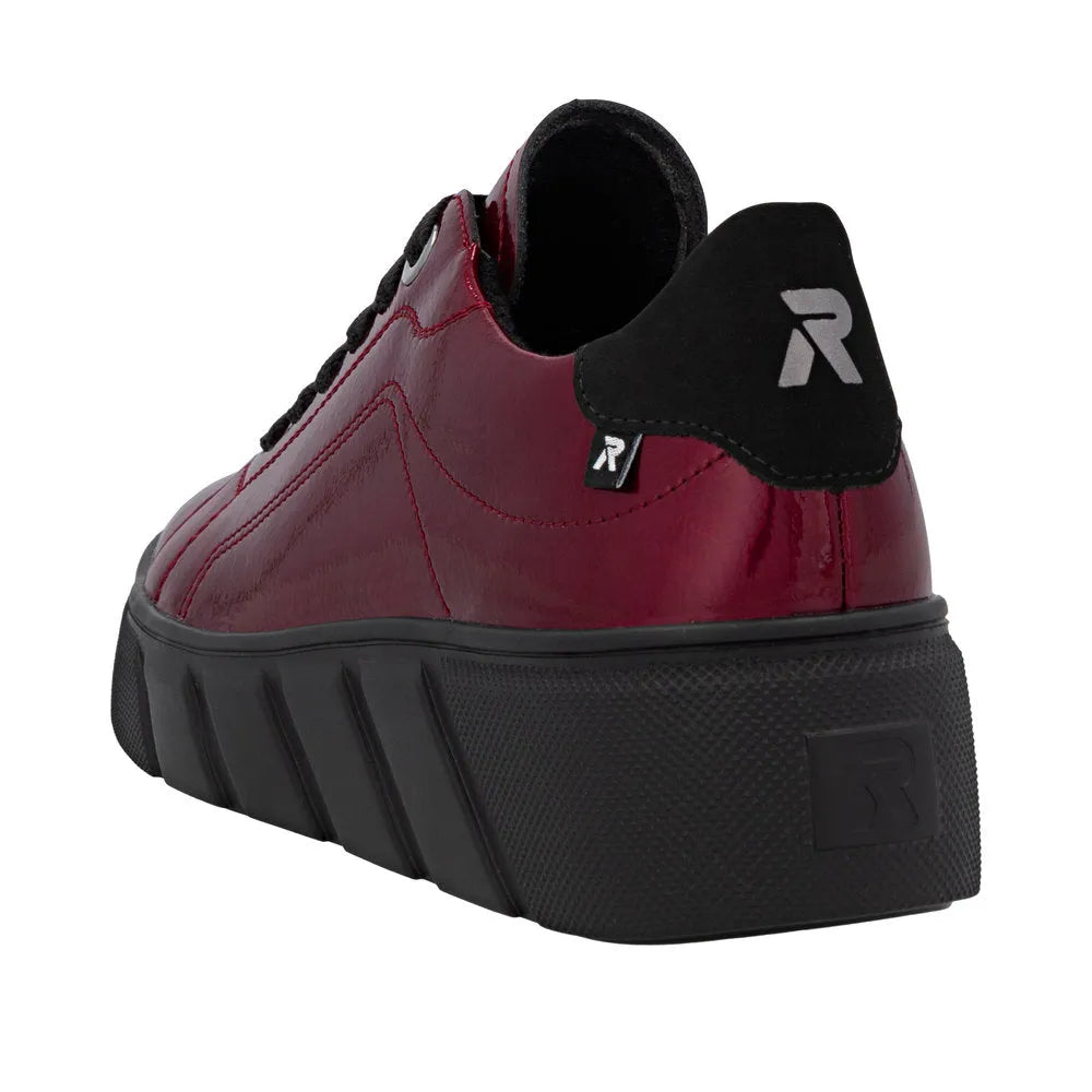 Rieker W2601-35 women's red patent leather lace-up trainers with black sole and logo back detail.