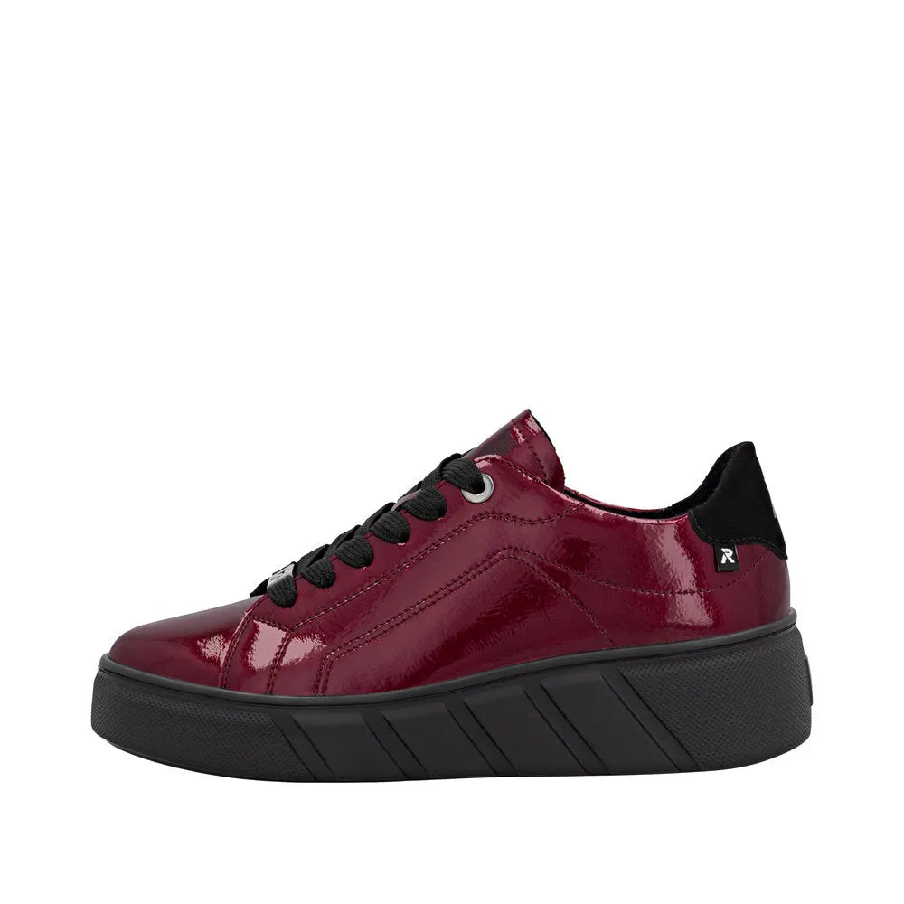 Rieker W2601-35 Ladies red patent leather lace-up trainers with black sole and accents.