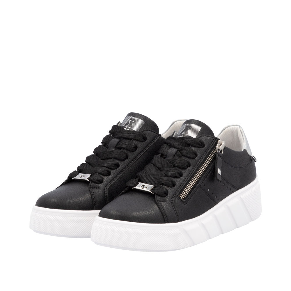 Rieker W2605-00 women's black leather sneakers with lace-up closure, side zipper, and chunky white sole.