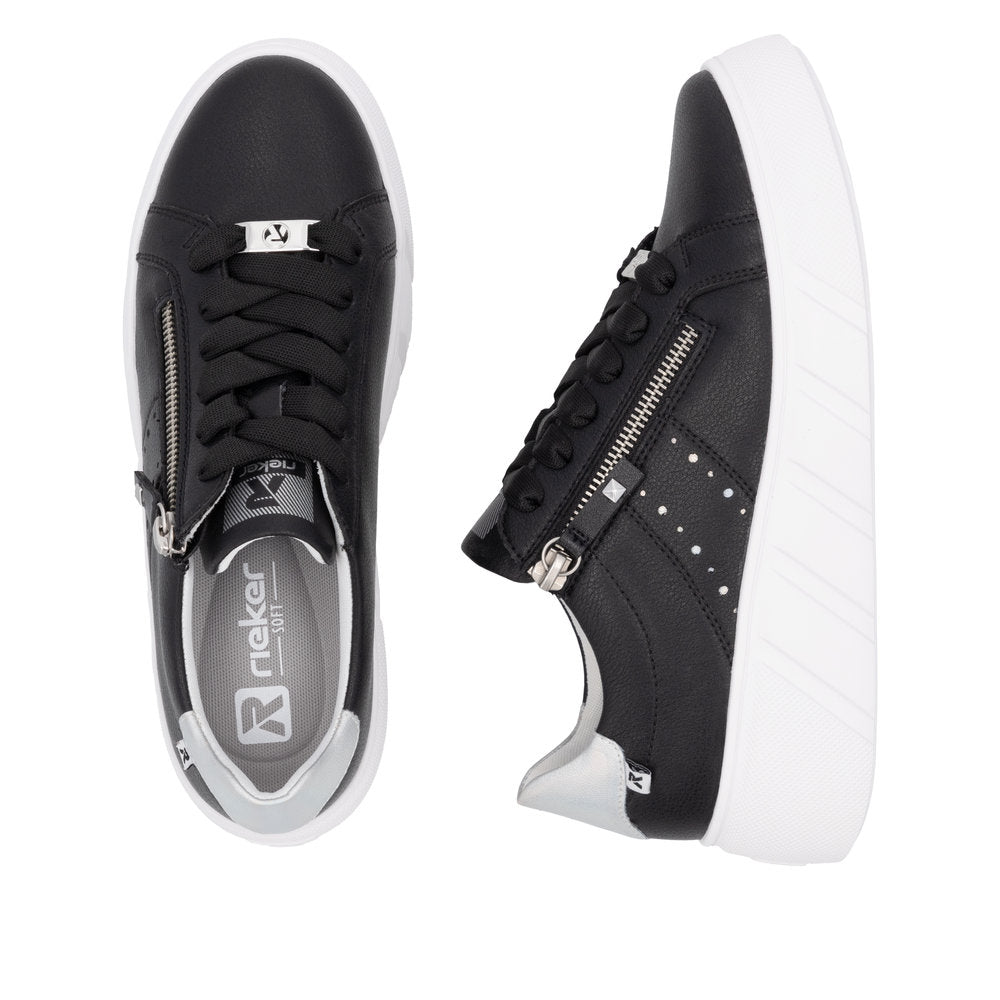 Rieker ladies' black leather sneakers with zip and lace-up closure, white sole, stylish design.