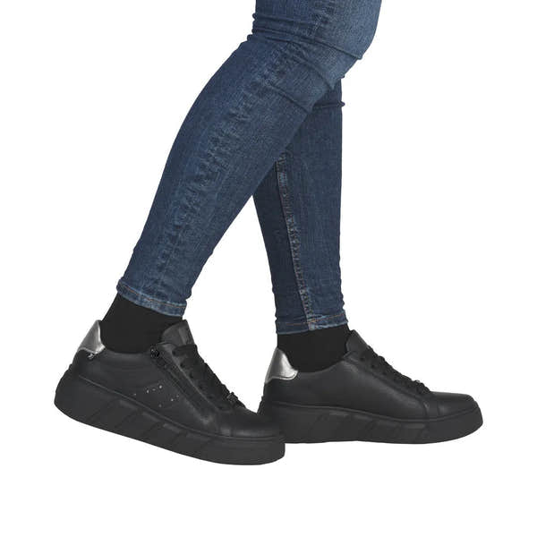 Rieker W2605-02 women's black leather trainers with zip and lace-up design, chunky sole, and silver accent on heel.
