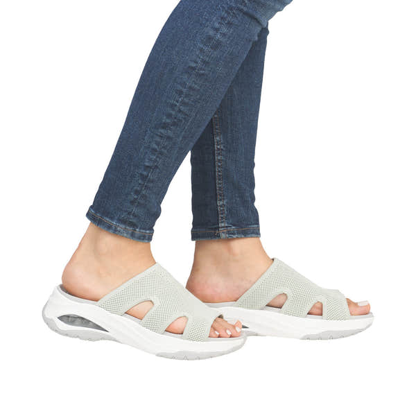Rieker W3150-52 women’s green textile vegan slip-on mules with cushioned sole and air cushion detail.