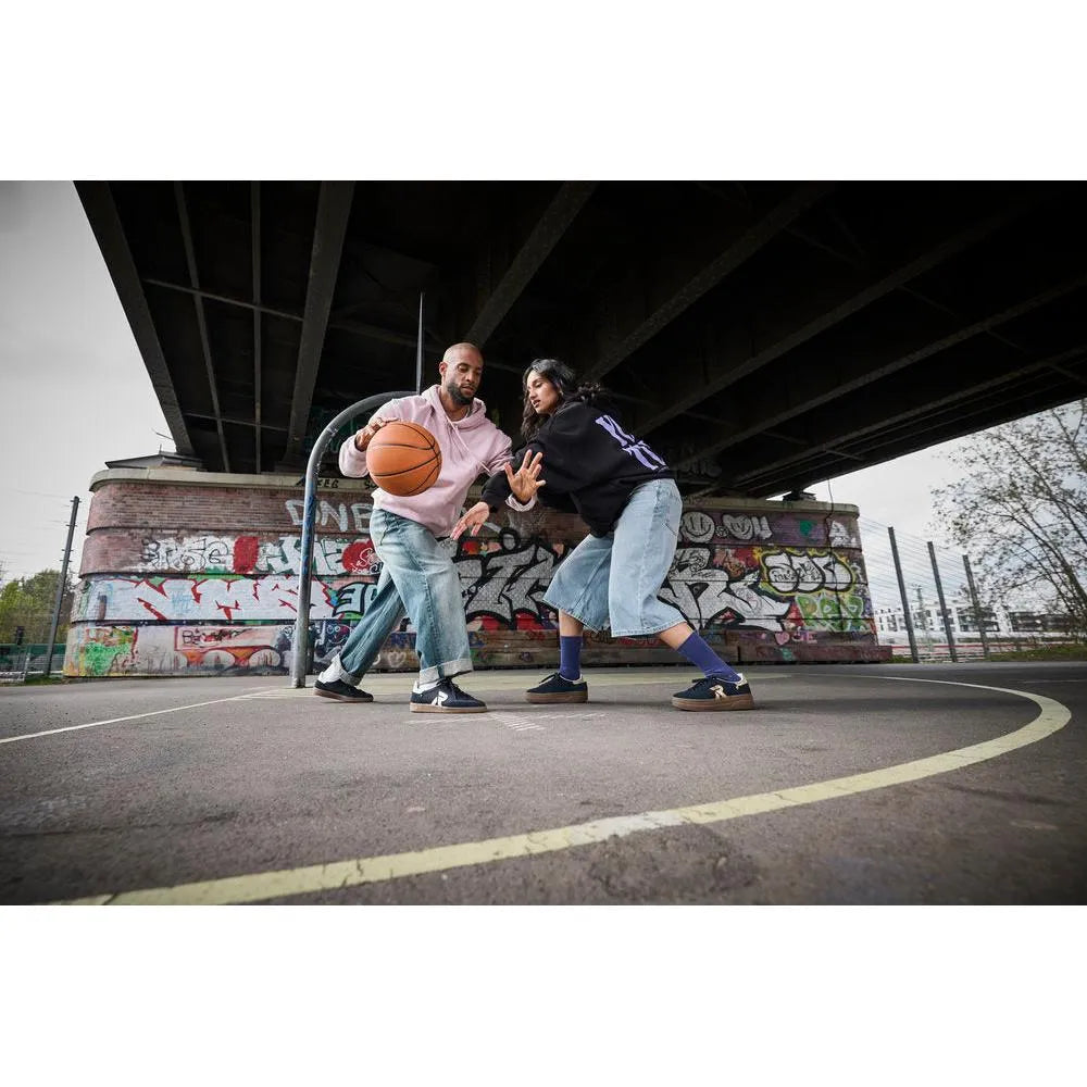 Rieker W3700-14 ladies blue suede lace-up trainers on a basketball court under a bridge.