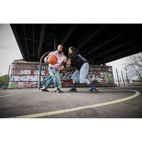 Rieker W3700-14 ladies blue suede lace-up trainers on a basketball court under a bridge.