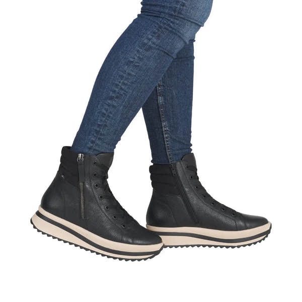 Rieker W3870-00 women's black leather ankle boots with zip, lace-up design, and chunky soles.