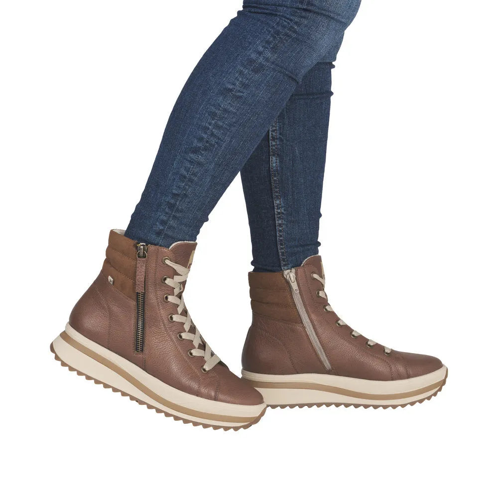 Rieker W3870-24 women's brown leather ankle boots with zip and lace-up closure, rugged sole, and stylish design.
