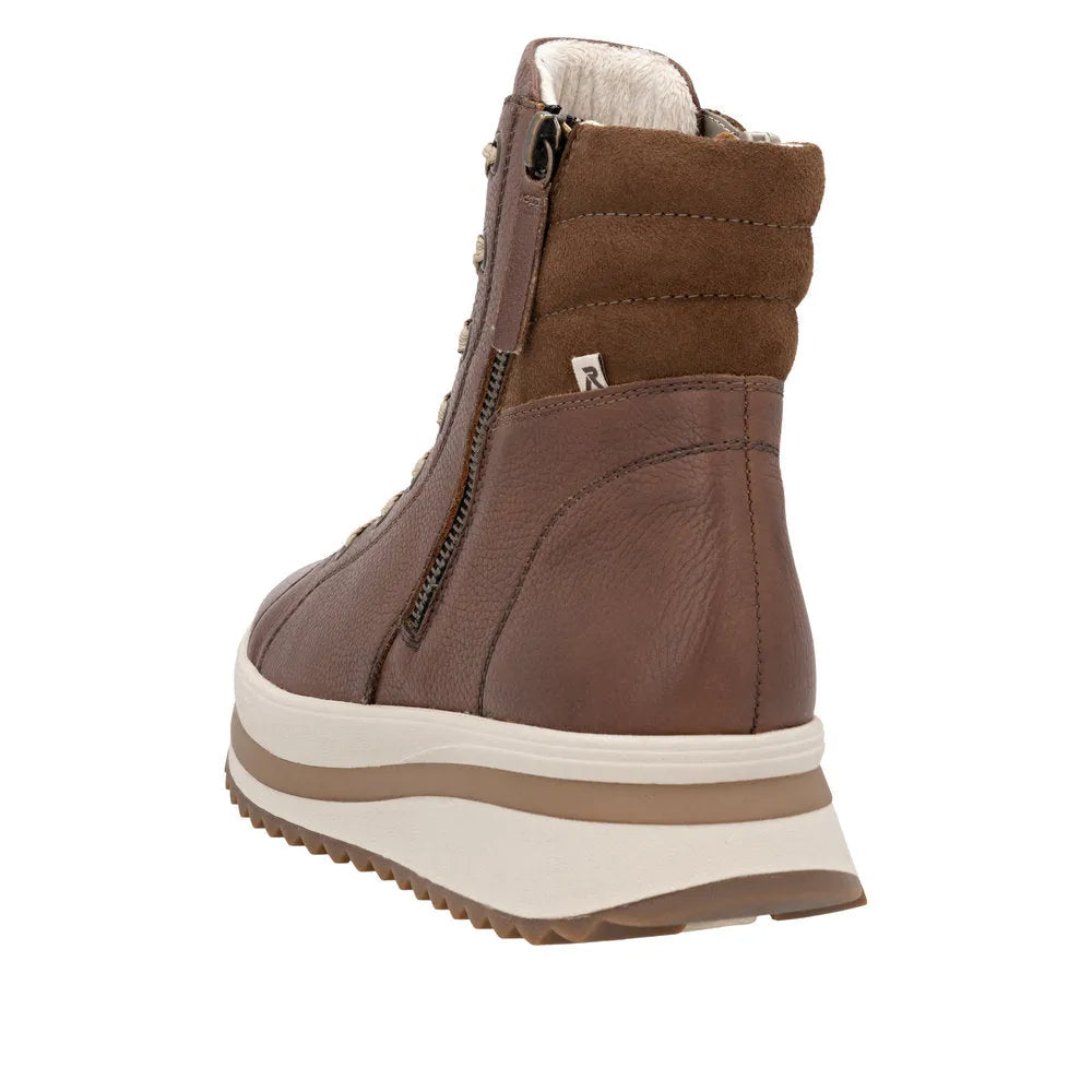 Rieker W3870-24 women's brown leather ankle boots with zip and lace-up design, cushioned collar, and chunky white & tan sole.