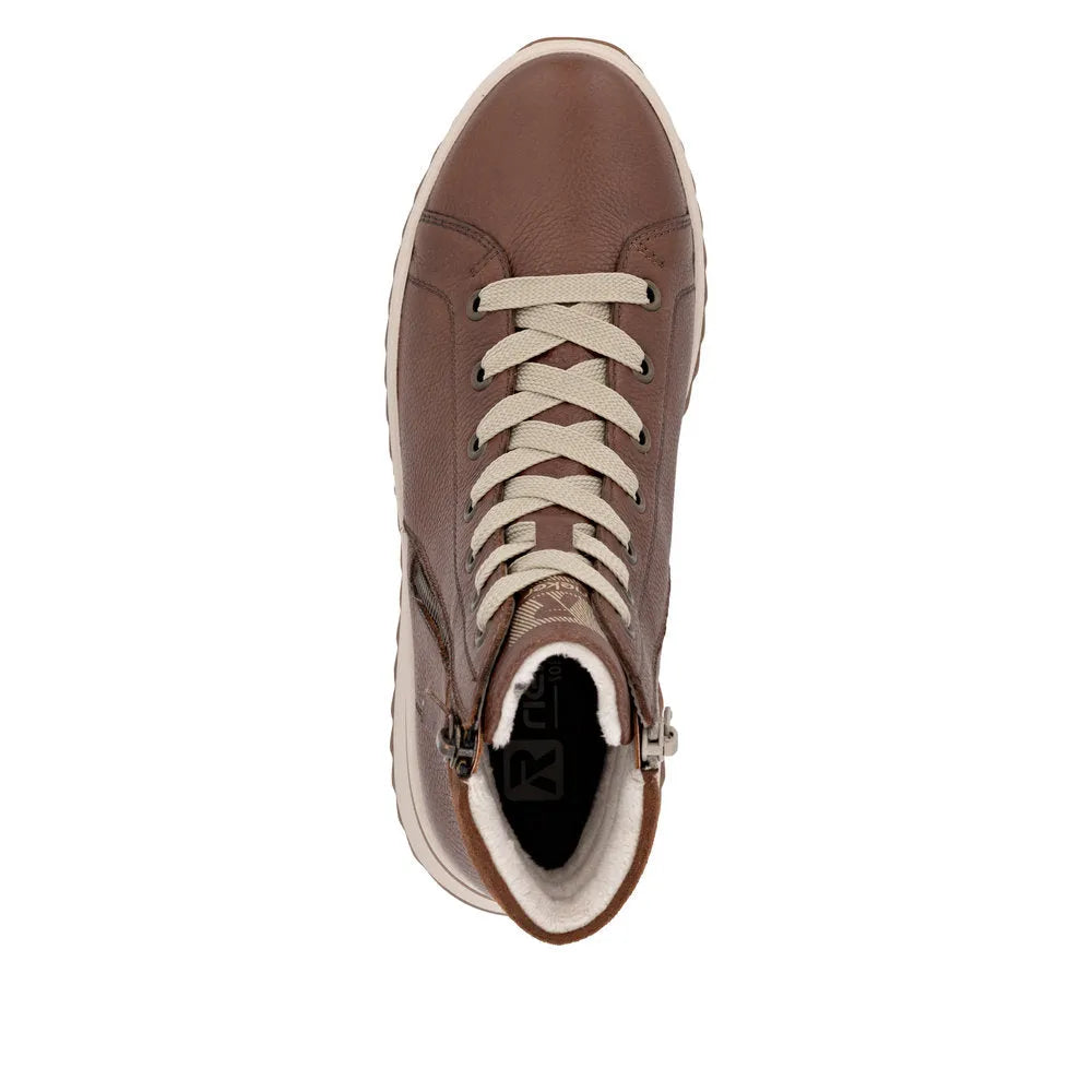 Rieker W3870-24 women's brown leather ankle boots with zip and lace-up closure, faux fur lining, and white sole.