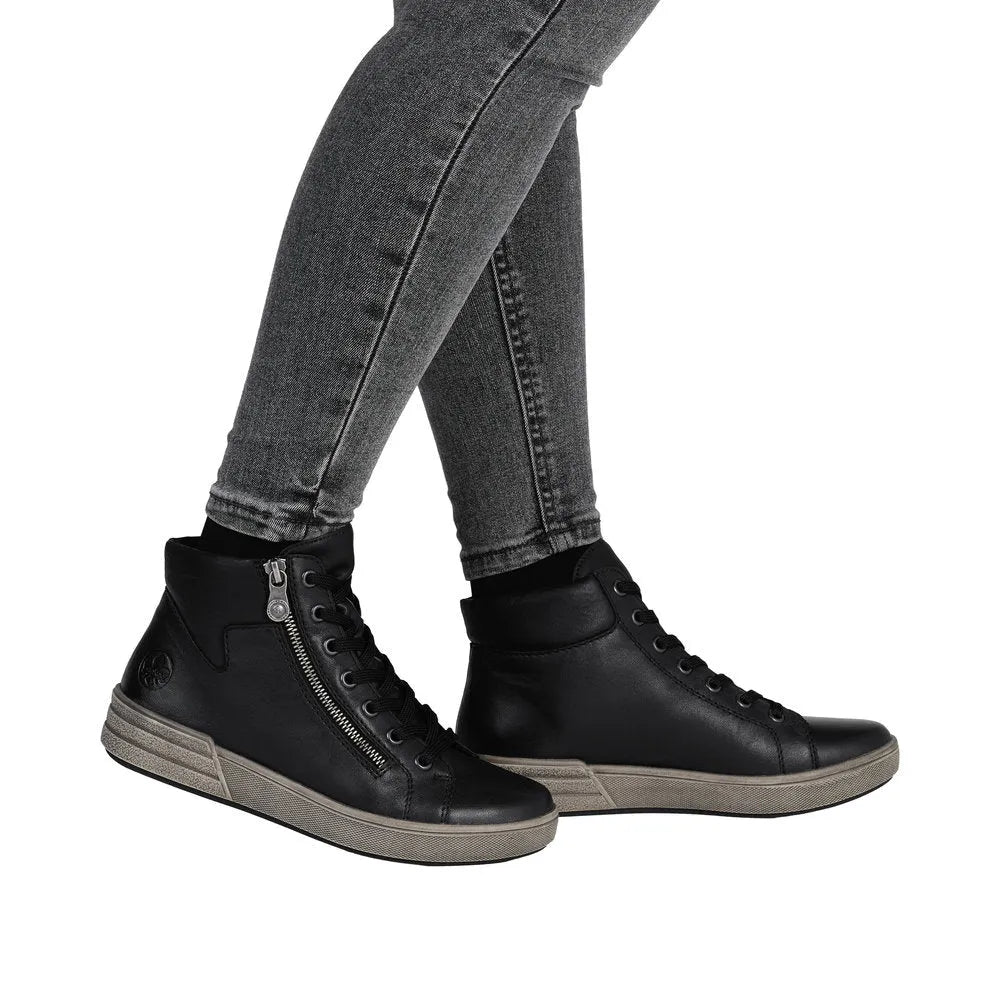 Women's black leather ankle boots with zip and lace-up detail, stylish and comfortable footwear.