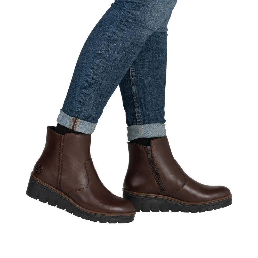 Rieker X9165-27 women's brown leather ankle boots with side zipper, chunky sole, and stylish design.