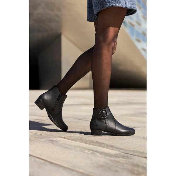 Rieker Y0797-00 women's black leather side zip ankle boots with low heel and decorative ankle detail.