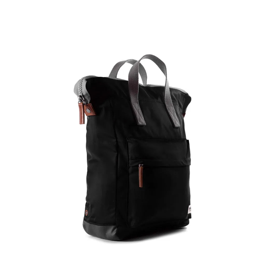 Roka Bantry B Black recycled nylon backpack with front pocket and gray handles, eco-friendly and durable design.