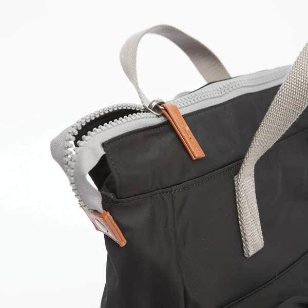 Roka Bantry B Black Recycled Nylon tote bag with beige straps and orange zipper pull, eco-friendly and stylish.