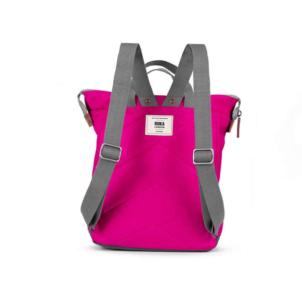 Roka Bantry B recycled nylon pink backpack with gray shoulder straps and a white logo patch, eco-friendly and stylish.