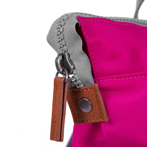 Roka Bantry B Candy recycled nylon bag with pink fabric, gray zipper, and brown leather accent. Eco-friendly and stylish accessory.