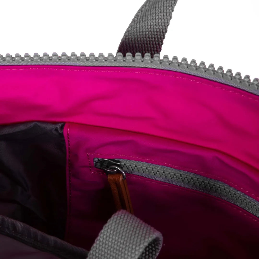 Roka Bantry B Candy recycled nylon backpack interior with pink lining and zippered pocket.
