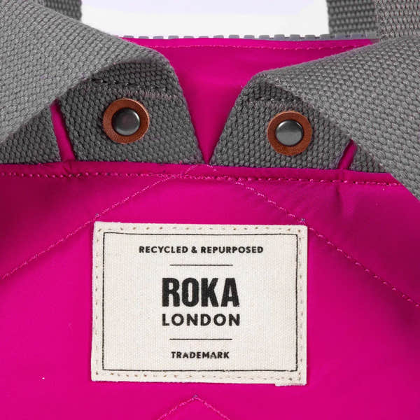 Roka Bantry B Candy recycled nylon jacket with gray knit collar and pink fabric, featuring a brand label and snap buttons.