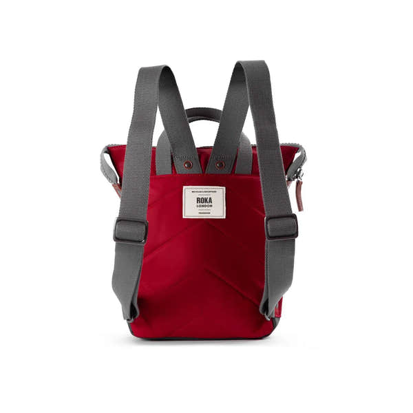 Roka Bantry B cranberry recycled nylon backpack with gray adjustable straps and front logo patch. Sustainable, stylish everyday bag.