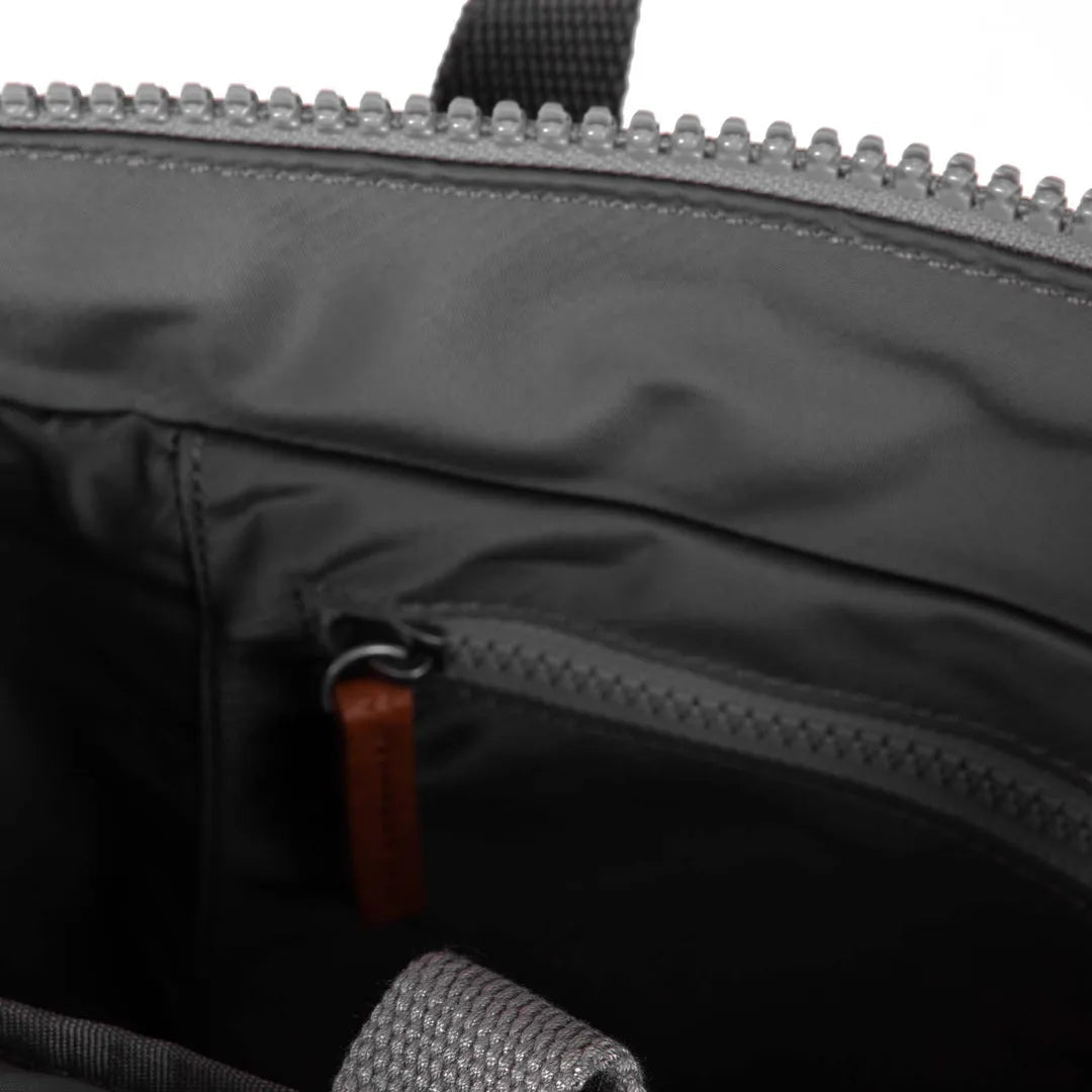 Interior view of a Roka Bantry B backpack showcasing graphite recycled nylon fabric with a zipper pocket and sturdy construction.