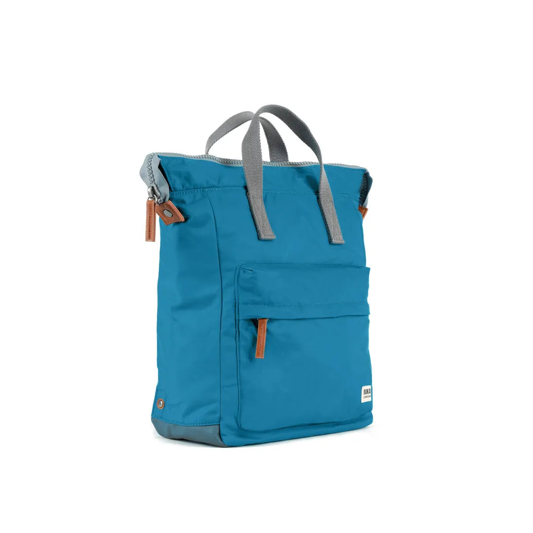 Roka Bantry B Marine recycled nylon backpack in blue with gray straps and leather accents, lightweight and eco-friendly.