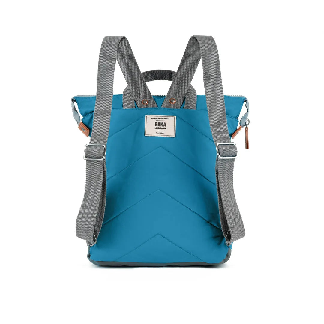 Roka Bantry B Marine recycled nylon backpack in vibrant blue with gray adjustable straps and a front logo patch.