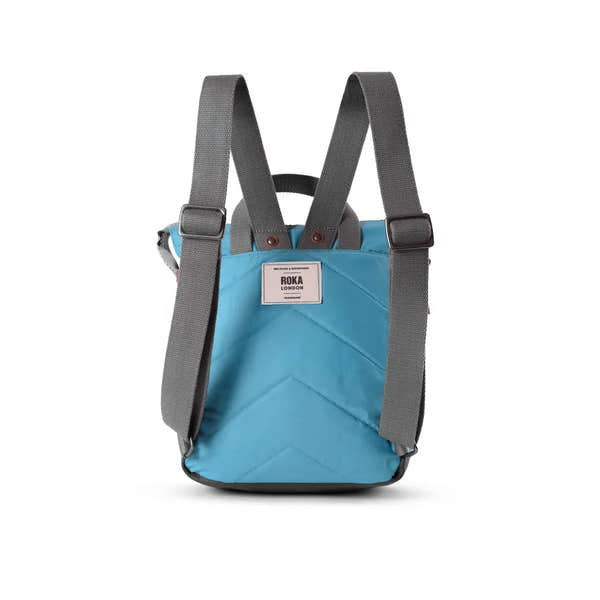 Roka Bantry B backpack made from recycled nylon PET material in blue with gray straps and logo label, eco-friendly and durable.