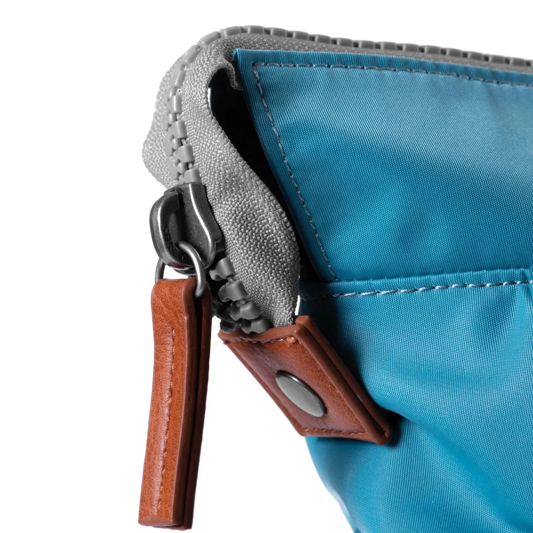 Roka Bantry B Petrol recycled nylon bag with grey trim, leather accent, and zipper closure.