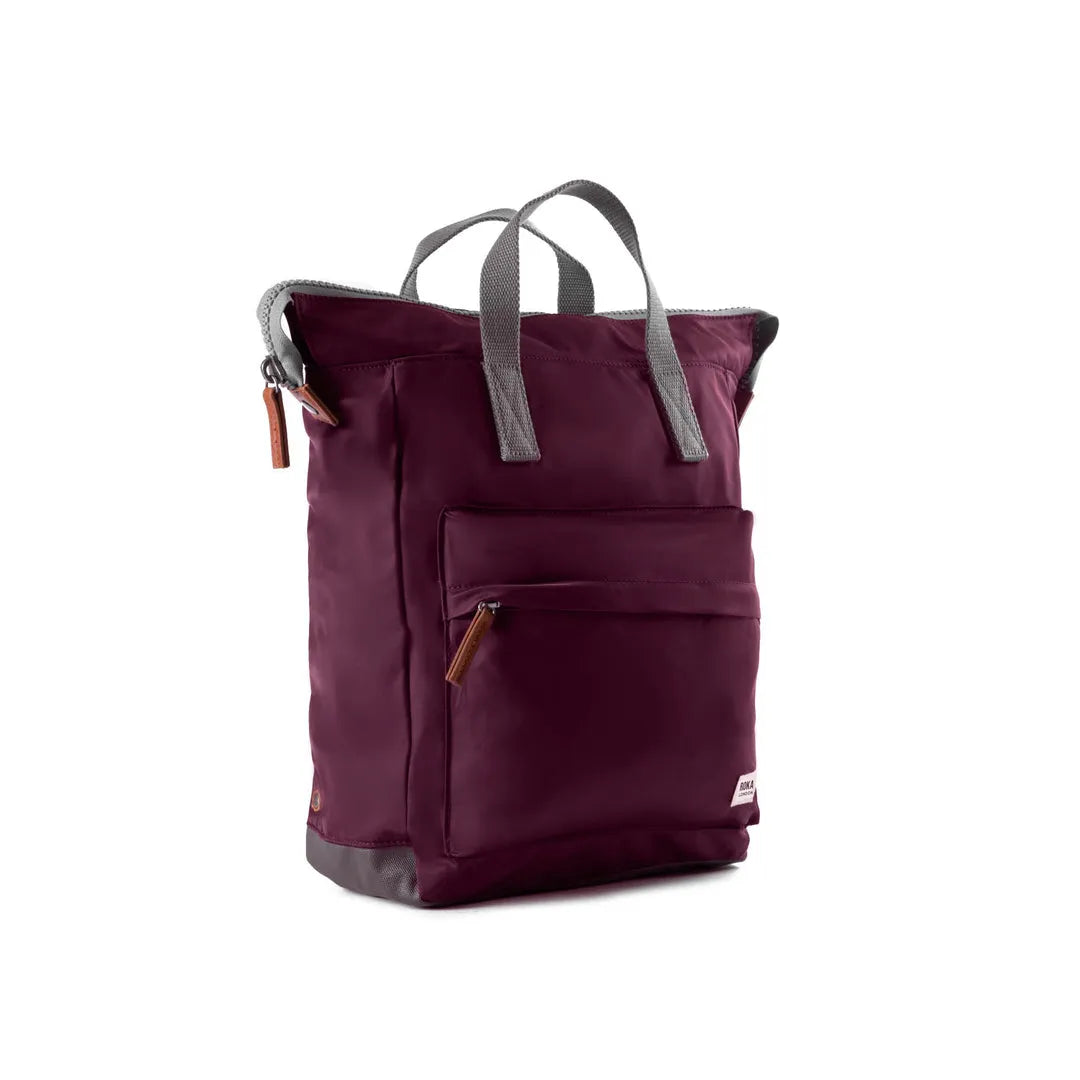 Roka Bantry B backpack made from recycled nylon, plum color, with front zip pocket, grey handles, and durable design.