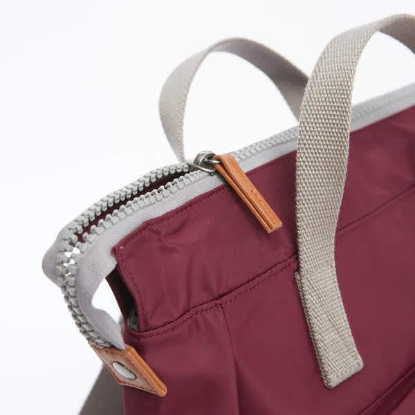 Roka Bantry B Plum recycled nylon tote bag with beige handles and leather zipper pull, eco-friendly and stylish accessory.
