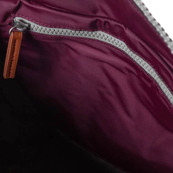 Roka Bantry B Plum recycled nylon backpack interior with zippered pocket and leather pull tab, eco-friendly and stylish accessory.
