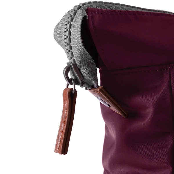 Roka Bantry B Plum recycled nylon bag with leather zipper pull and gray trim, showcasing durable and eco-friendly material.