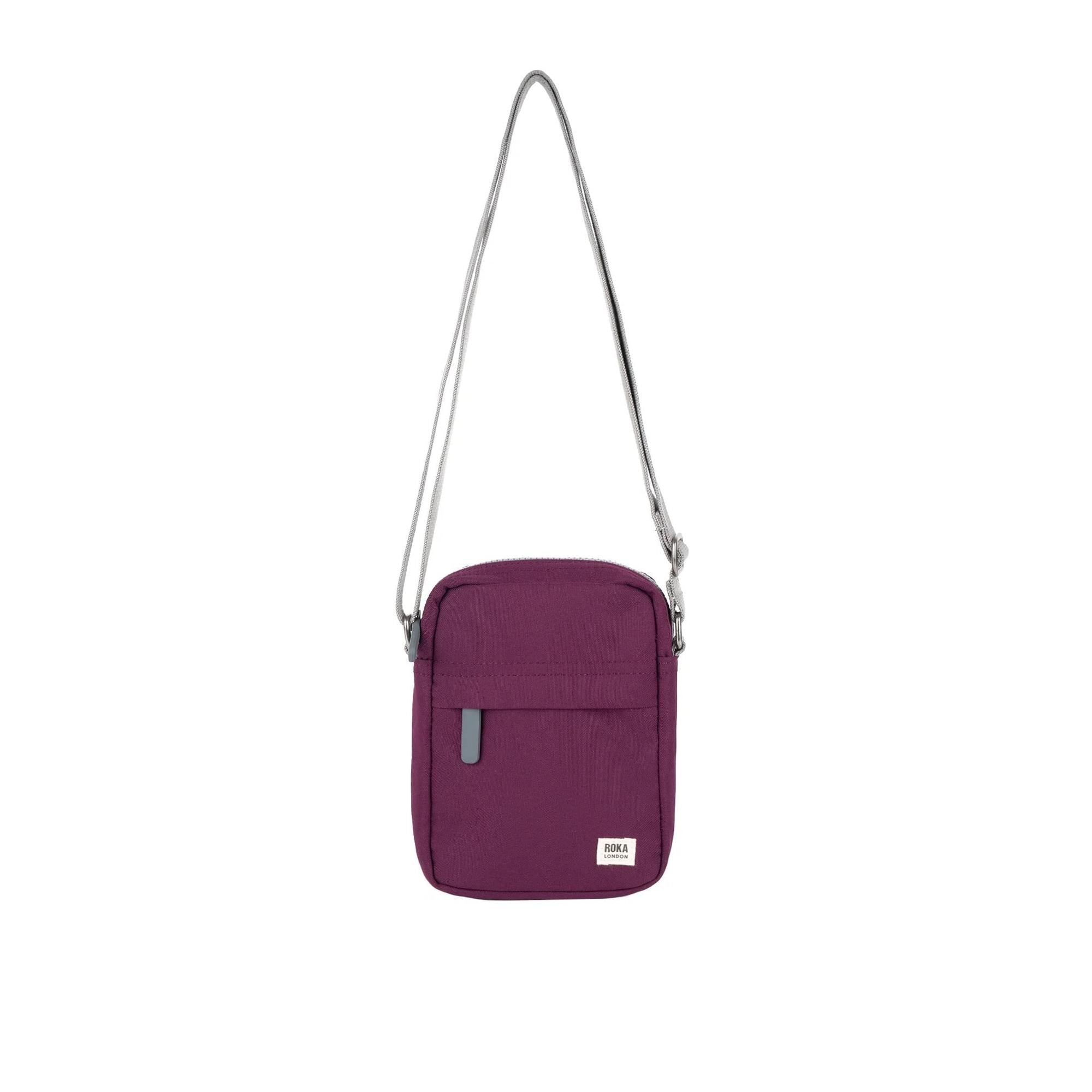 Roka Bond Cherry Lacquer recycled canvas crossbody bag with adjustable strap, one size, front pocket, and logo detail.