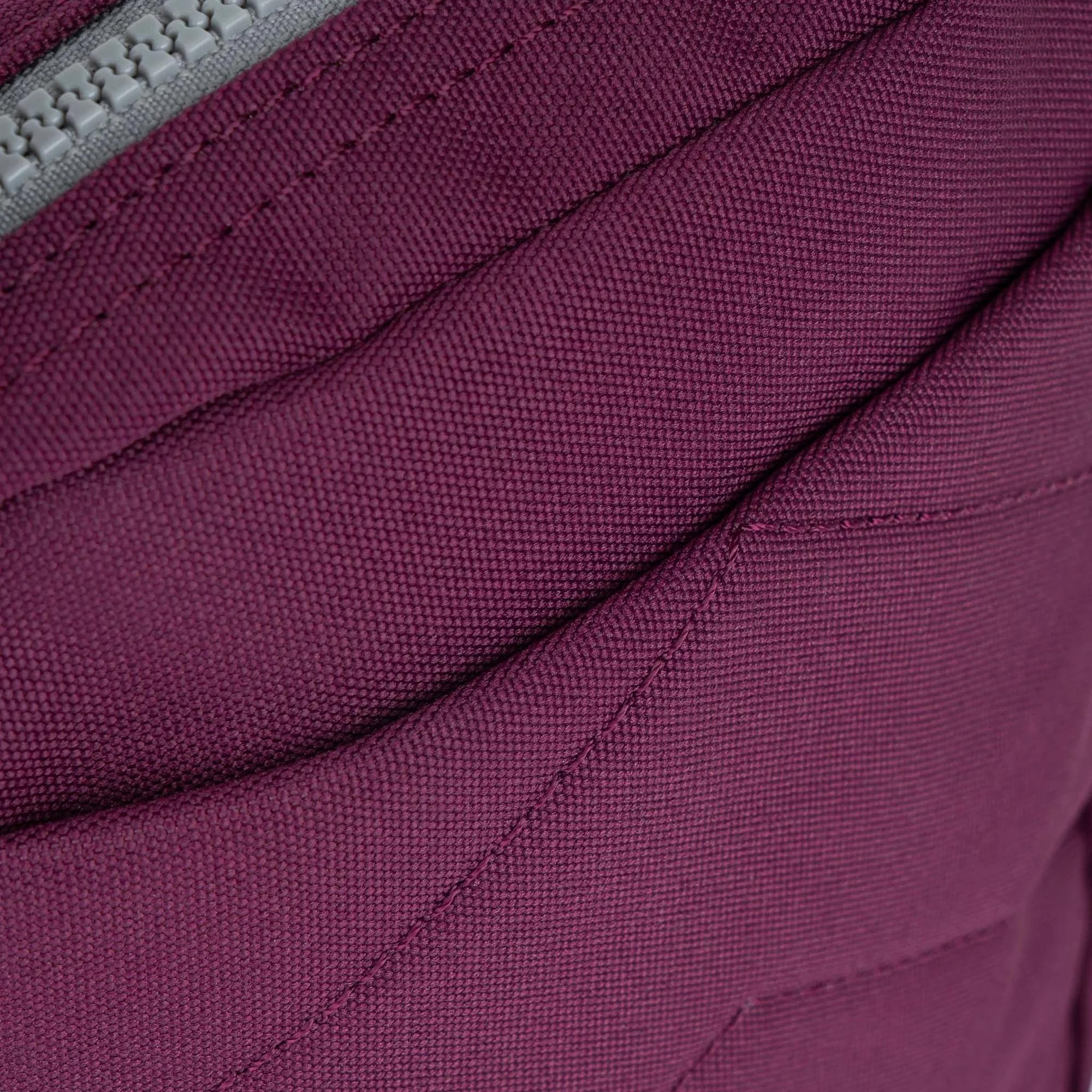 Roka Bond Cherry Lacquer recycled canvas bag, one size, close-up of textured deep red fabric and stitching detail.
