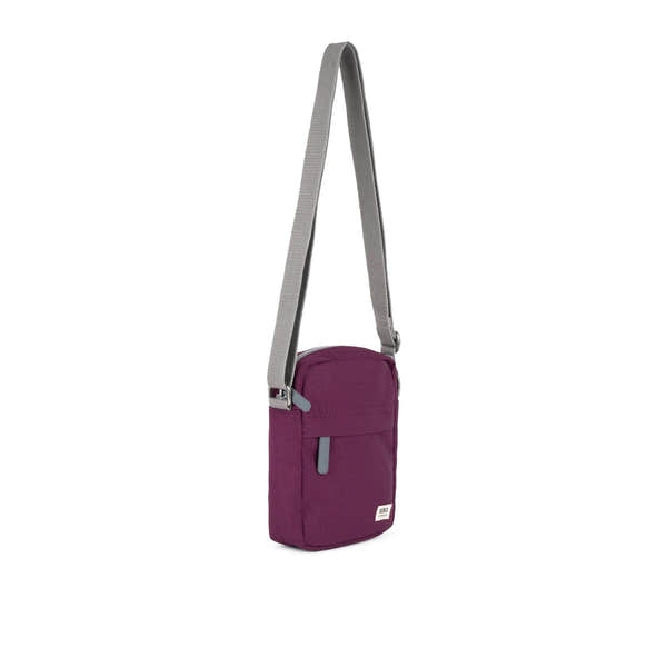 Roka Bond Cherry Lacquer Recycled Canvas small crossbody bag with gray adjustable strap and front zipper pocket.