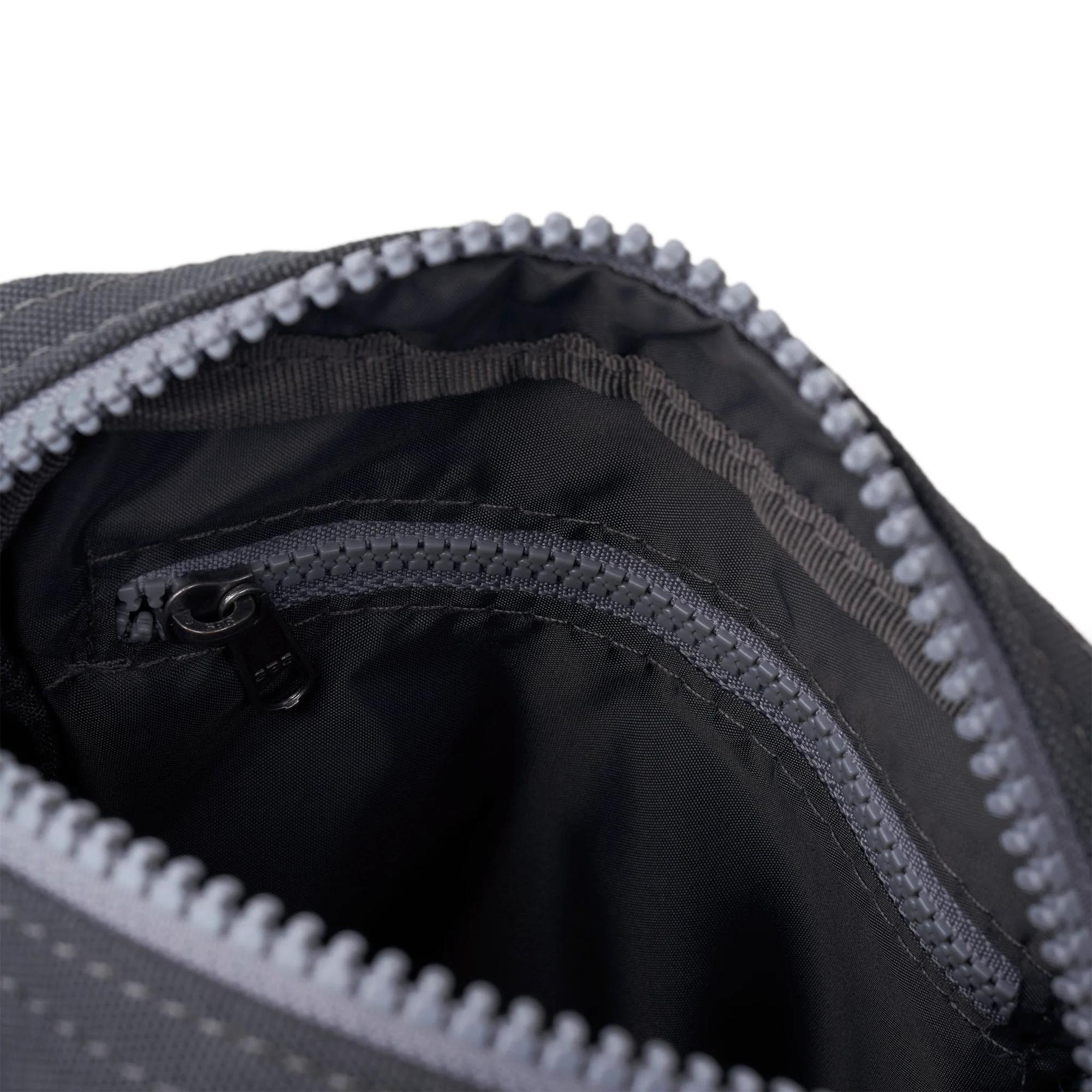 Roka Bond faded black recycled canvas backpack with multiple interior zippered compartments, one-size, durable design.